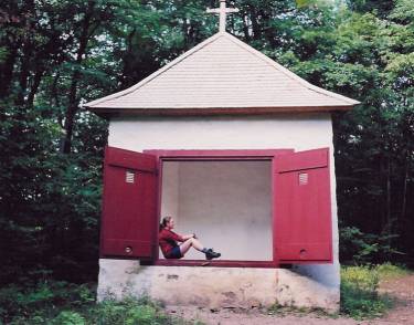 Margot sitting in a chapel at Parc d'Oka