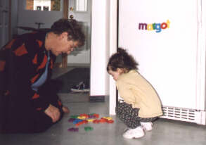 Genevi�ve spelling her aunt Margot's name on the fridge