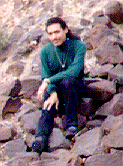 A picture of me sitting on rocks.