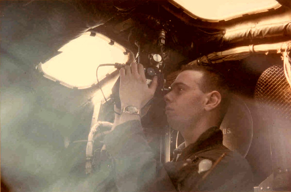 19th Air Refueling Squadron navigator Gerry Dornfeld taking a celestial shot through the sextant in order to plot his position on the Earth.