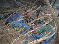 Getting ready for bed under the shelter they built