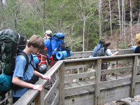 Troop looking over bridge they are crossing