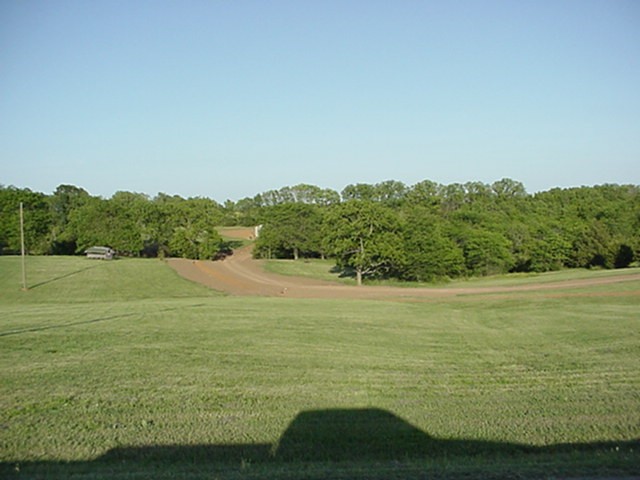 Here's the front view from last summer. Before Gravel. Trees hide the house from the Road.