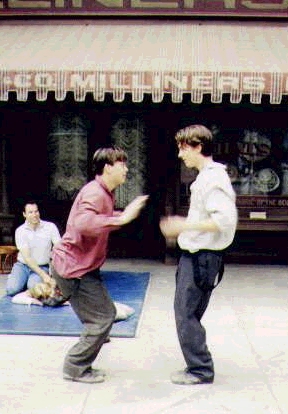 Kevin and Christian Bale playing a game on the set of "Newsies"