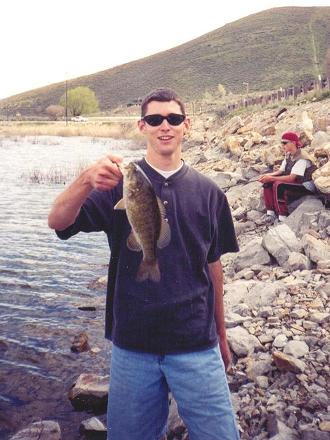 A nice Deer Creek Reservoir <a href='http://www.utahfishinginfo.com/utahfish/smallmouthbass.php'>Smallmouth Bass</a> caught on a Banjo Minnow on a warm, overcast summer morning.&nbsp; In the background is my little brother, Brett.