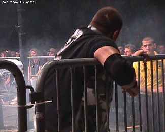 Baseball slide by Edge into the table sends the Dudleyz into the railing