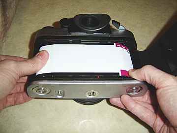 roll film on while maintaining presure on both spools