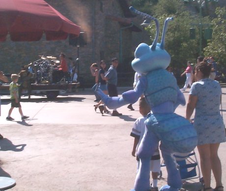 That kid is as good as eaten. Also, the band playing on the passing vehicle are not as good as that black guy's hat.