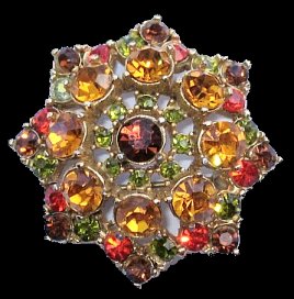 Sphinx-signed autumnal 8-point star brooch 