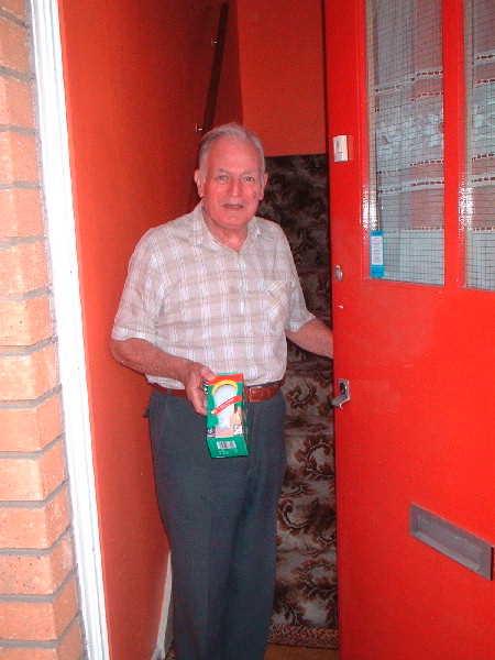 A timebank particpant recieves a compact fluorescent lightbulb award