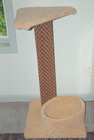 Brown post with tan shelf and bed.