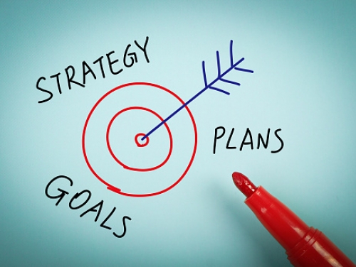 Image of an arrow hitting bullsye while surrounded by the words Goals, Strategy, Planning