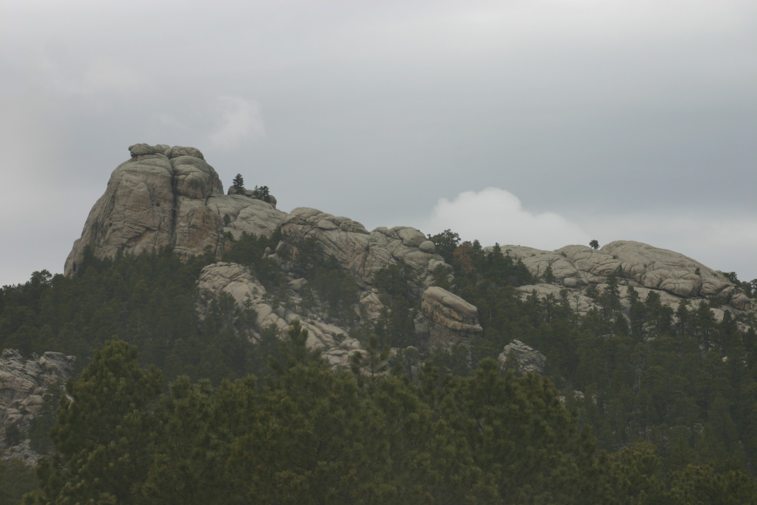 The interesting shape of the rock formation in front reminded me of a bus that was slightly smushed on top.&nbsp; Taken near Mt. Rushmore.