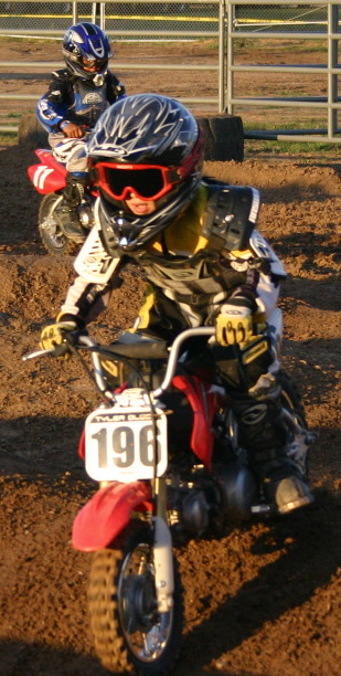 These two little boys riding their mini motocross bikes were working their hardest to complete the race.
