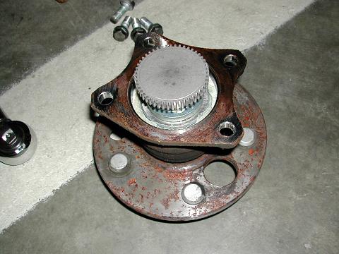 The rear wheel hub removed (see the teeth and the white grease on the bearings below))