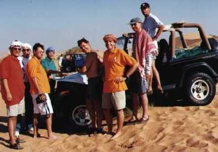 Expat bedu's studying the maps of the Wahiba Sands