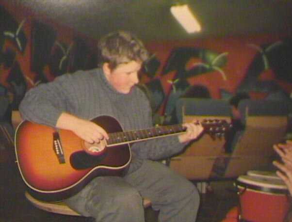Lu playing the guitar