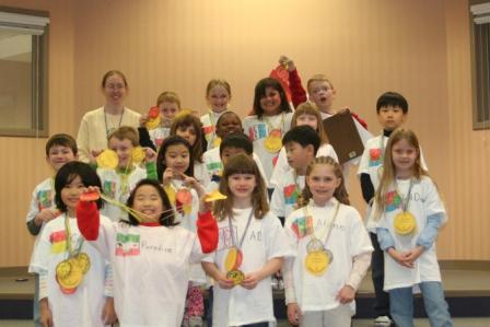 Natalie posing on the medal platform with her second grade class.