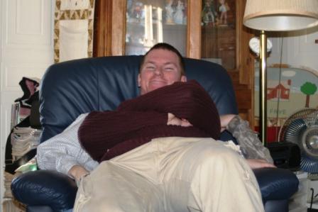Kyle "sharing" a chair with Natalie's cousins at Thanksgiving.