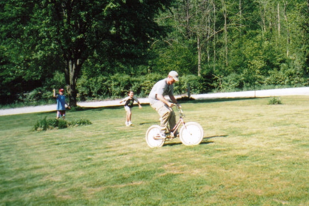 Kyle highjacking Natalie's childhood bicycle from our neice Kayla