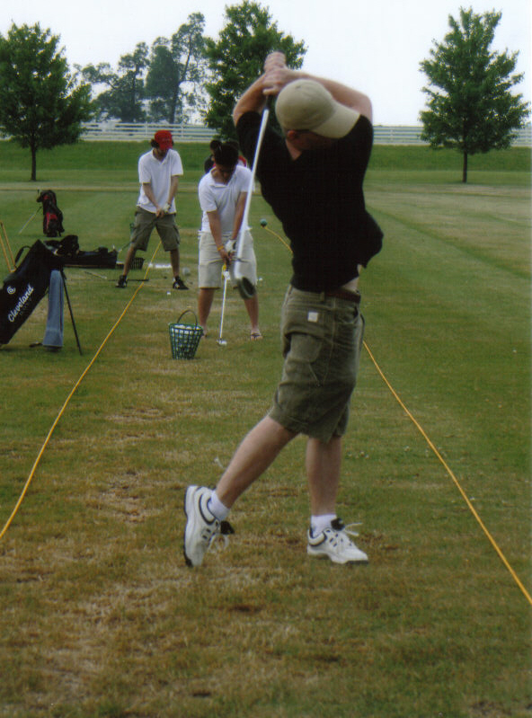 Kyle fine tuning his swing at the driving range minutes from our house.