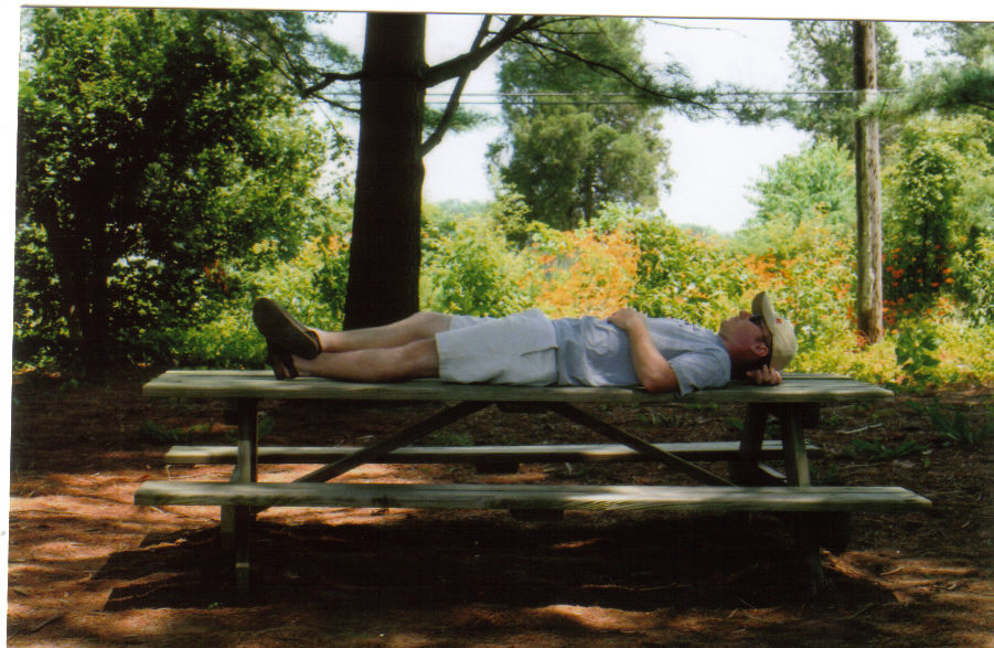 Kyle napping on a picnic table on vacation in Ohio.