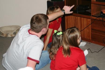 Kyle playing video games with neices Kayla, Jessica, Ally, and Kelsey