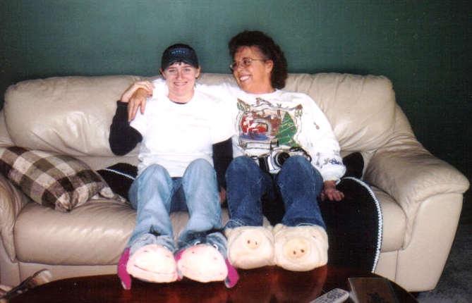 Natalie's sister and Mom showing off their new Christmas slippers.