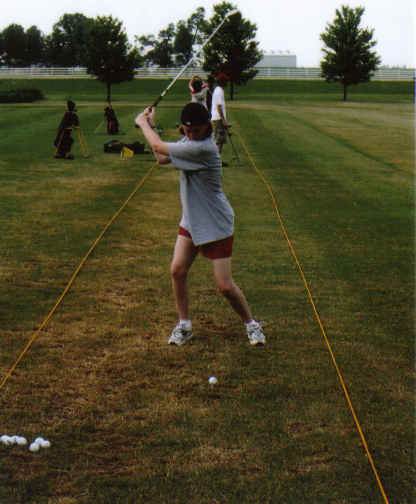 Natalie hitting some balls at the driving range.