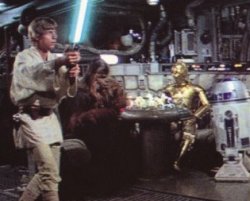 A game of dejarik is played in the background as Luke trains with a remote
