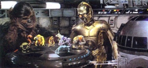 Chewbacca and R2-D2 play dejarik while C-3PO spectates