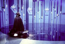 Vader kneels before the holo projector in his chamber