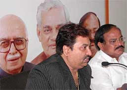 Noted singer Kumar Sanu addresses a press conference after joining the BJP in New Delhi on Tuesday. BJP President M. Venkaiah Naidu is also seen in the picture