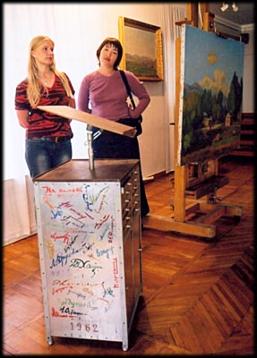 Birthday present in foreground with signatures of other artists