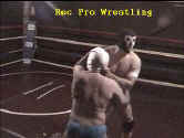 L.S. Powerhouse grabs Barefoot Boy by the mask.