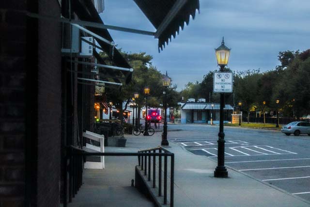 A street in essex with a bus and street light inframe with some trees in the back
