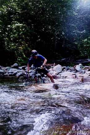 Xavier crossing a river during the goldMyer hot spring ride in 1995