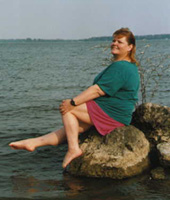 Me on a rock by the water.