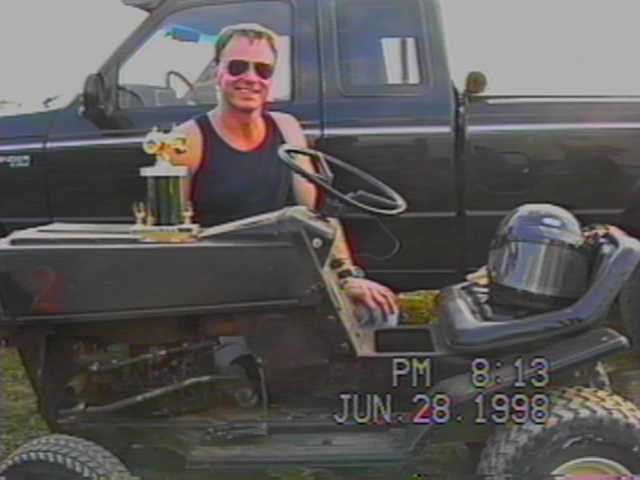 RICHARD DUNLAVY WITH THIS MOWER/TROPHY