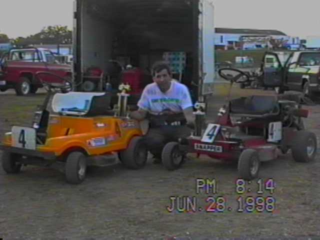 NATE HENDRICKS WITH HIS TWO MOWERS AND TROPHIES