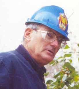 Mr. Dexter wearing his famous Pokemon hard hat at a job site as he gives advice to his students.