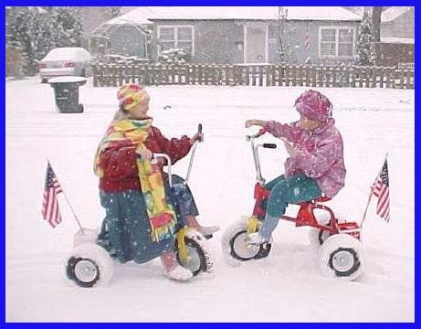 Girl playing in the snow on there wheels.