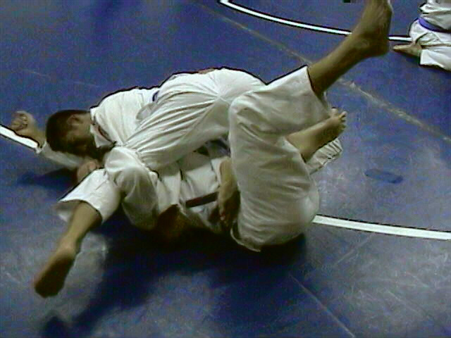 Hug his left leg high on shoulder, roll to your left
