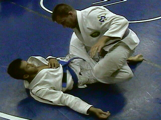 Lean forward and give him a hug for the calf/hip/knee submission