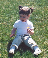 Lexie smelling the dandelions!