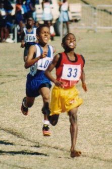 U-11 athletes (St. Kitts & Nevis) compete in the 800m, and U-11 Long Jumper from Nevis