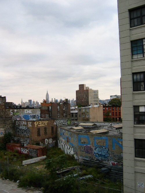 View of yard on shore and graffiti, from the Williamsburg Bridge