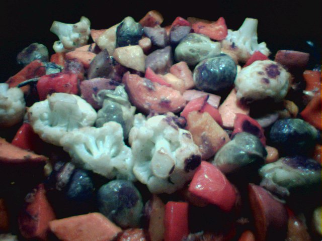 Vegetables, slowly roasted, including cauliflower, brussels sprouts, sweet potatoes, red bell peppers, and mushrooms
