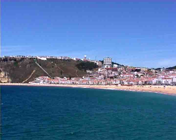 Fatima tour - Nazare beach seen from a fishing boat in the ocean.