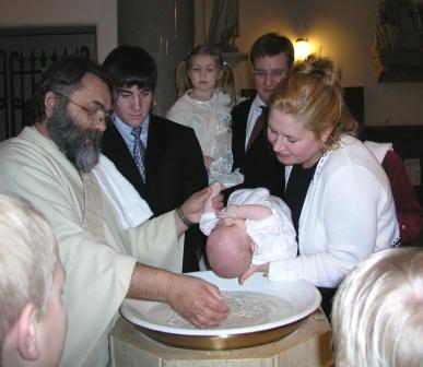 Deacon Claude baptizes Thomas